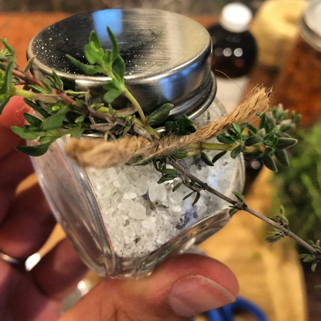 selective focus photo of person holding jar of white salt